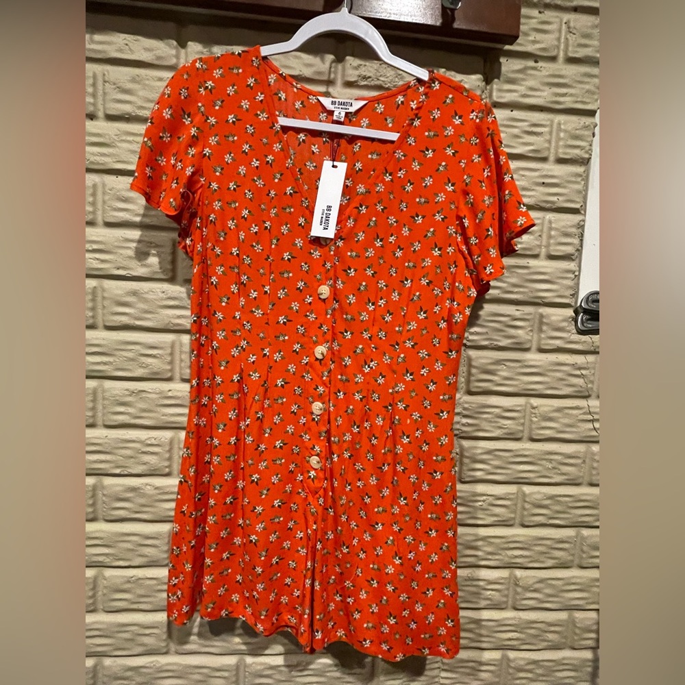 BB Dakota romper. Orangish-red with flowers. Never worn